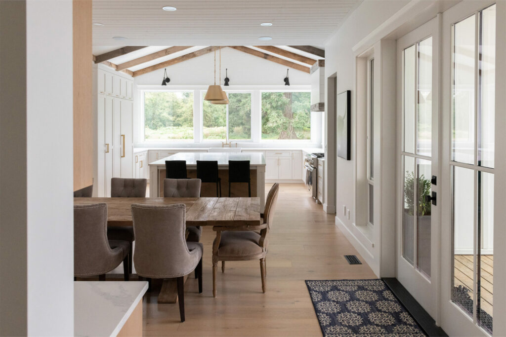 Stylish brown laminate flooring in a large kitchen leading into the dining area by A&S Carpet Collect in Allison Park, PA.
